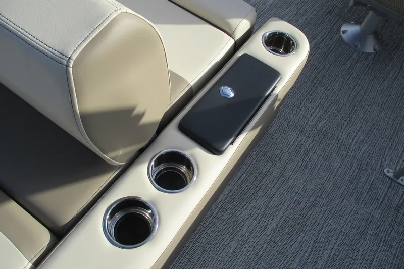 Slide: The Image of 2026 SunCatcher Select 22SL boat interior with cup holders and armrest. - 23