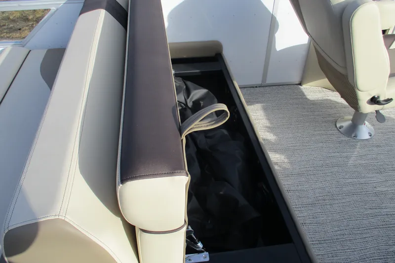 Slide: The Image of 2026 SunCatcher Select 22SL boat interior with open storage compartment and seating. - 25