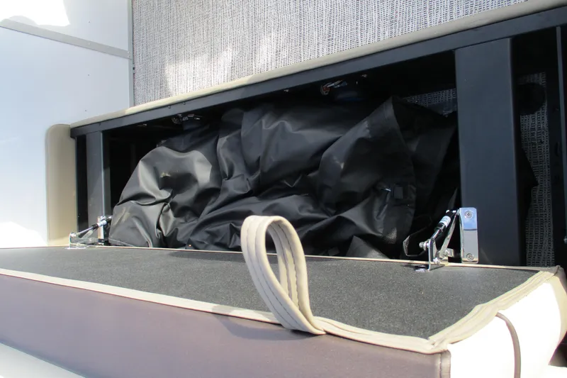 Slide: The Image of 2026 SunCatcher Select 22SL storage compartment with black cover and latch details. - 26