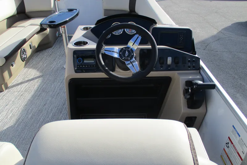 Slide: The Image of Interior view of 2026 SunCatcher Select 22SL boat, featuring steering wheel and seating area. - 27