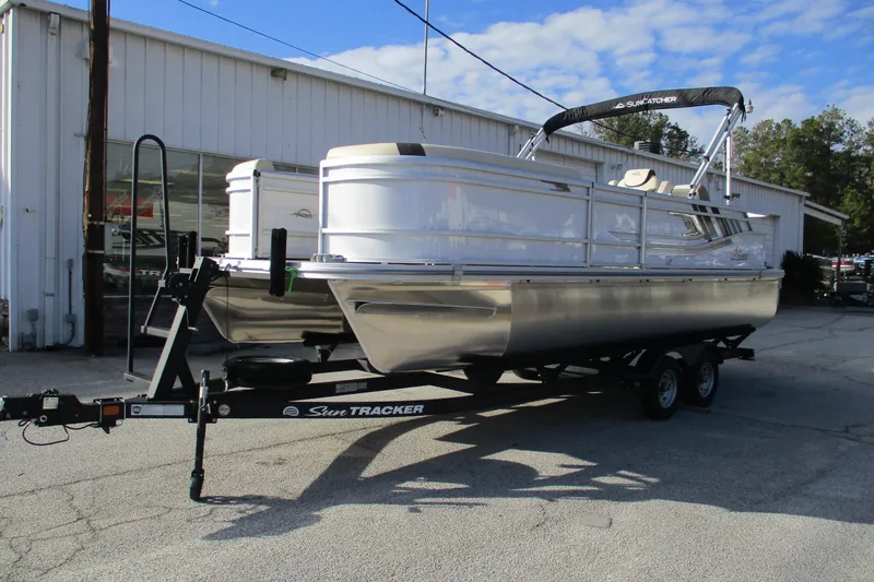 Slide: The Image of 2026 SunCatcher Select 22SL pontoon boat on trailer outside dealership. - 3