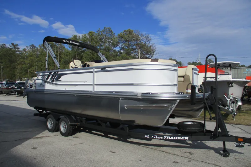 Slide: The Image of 2026 SunCatcher Select 22SL pontoon boat on trailer, parked outdoors. - 5