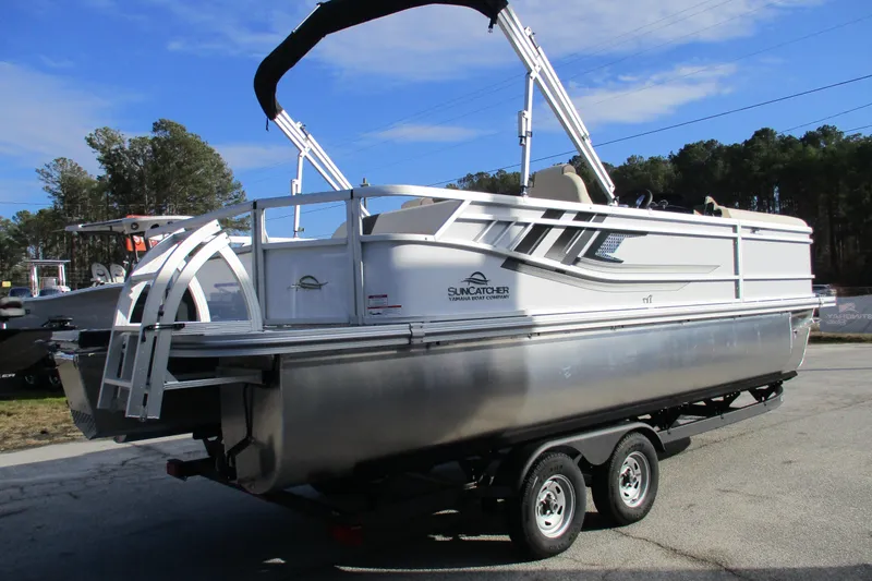 Slide: The Image of 2026 SunCatcher Select 22SL pontoon boat on trailer, parked outdoors. - 7