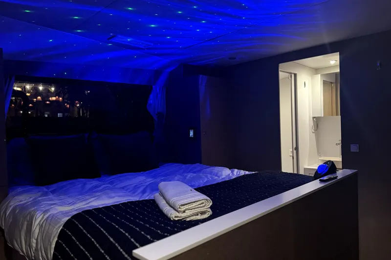 Slide: The Image of Luxurious NEEL 51 yacht bedroom with ambient blue lighting, 2020 model. - 18