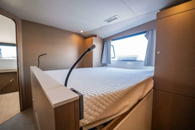 Slide: The Image of Modern bedroom interior on NEEL 51 trimaran, 2020 model, featuring a cozy bed and window view. - 19