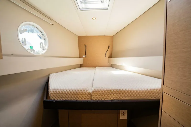 Slide: The Image of Interior cabin of 2020 NEEL 51 with a comfortable bed and porthole window. - 22