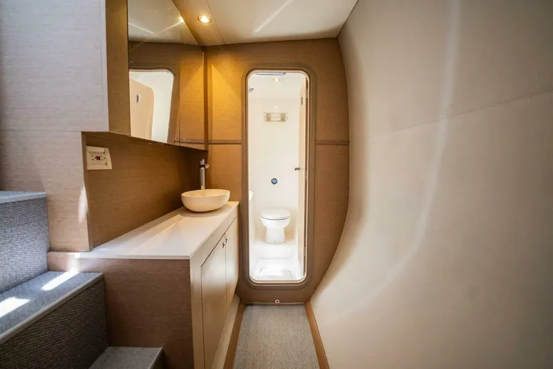 Slide: The Image of Modern yacht bathroom interior with sleek design, featuring a sink and toilet. NEEL 51, 2020 model. - 24