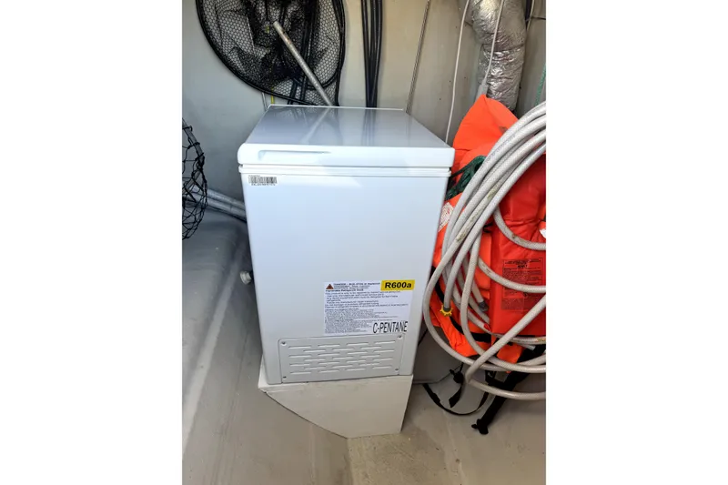 Slide: The Image of Compact white freezer in a storage area with safety equipment, NEEL 51 model, 2020. - 27