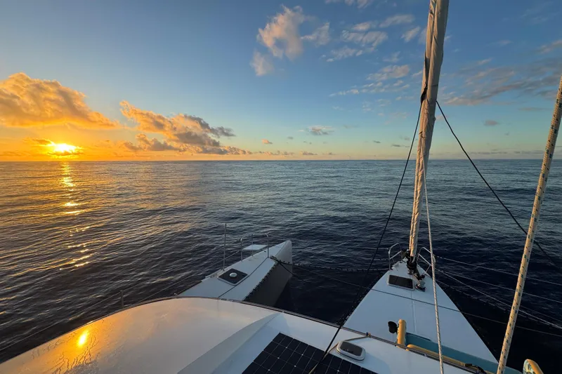Slide: The Image of Sailing on NEEL 51 trimaran at sunset, 2020, with serene ocean view. - 4
