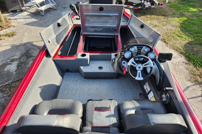 Slide: The Image of 2021 Tracker Pro Team 175 TXW Tournament Edition boat interior with steering console and storage compartments. - 13