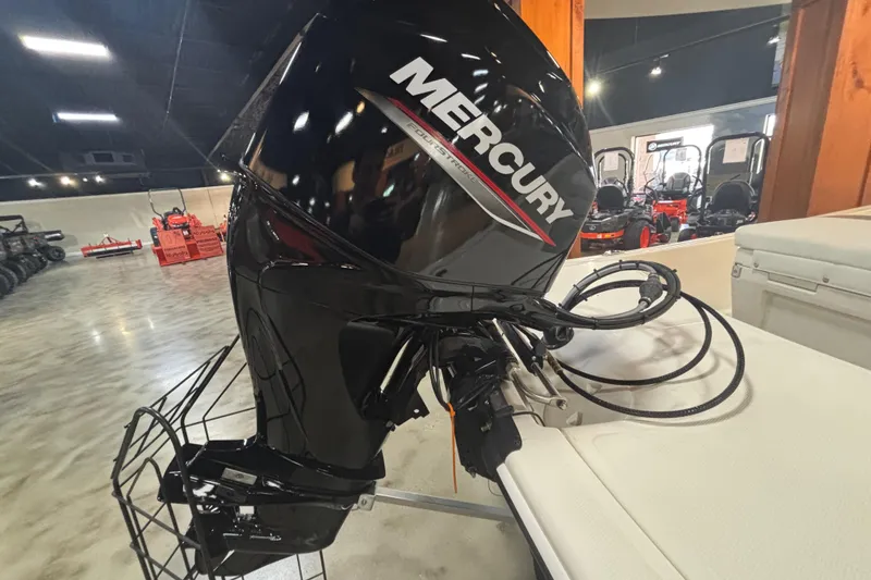 Slide: The Image of 2024 Mako Pro Skiff 15 CC with Mercury engine in showroom. - 2