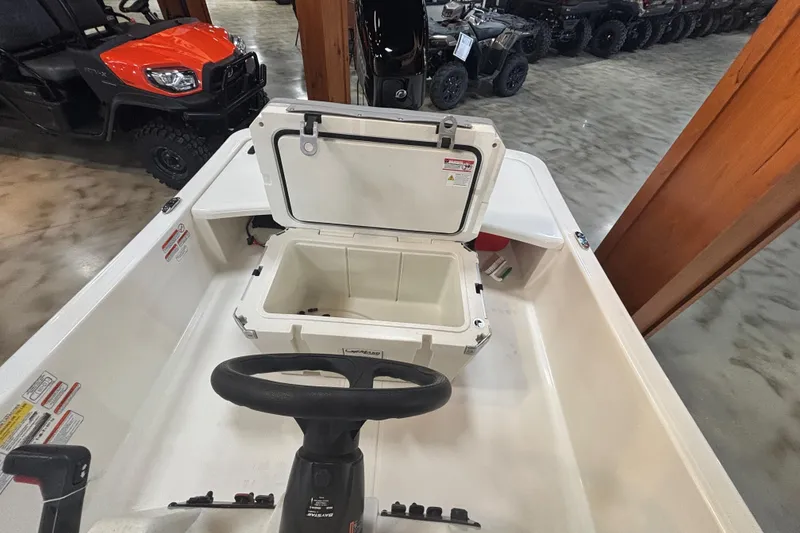 Slide: The Image of Interior of 2024 Mako Pro Skiff 15 CC with open storage compartment. - 7