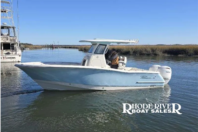 Slide: The Image of 2026 Pioneer 250 Pelagic boat on calm water, showcased by Rhode River Boat Sales. - 13