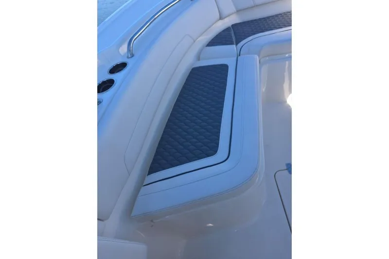 Slide: The Image of 2026 Pioneer 250 Pelagic boat interior with cushioned seating and cup holders. - 14