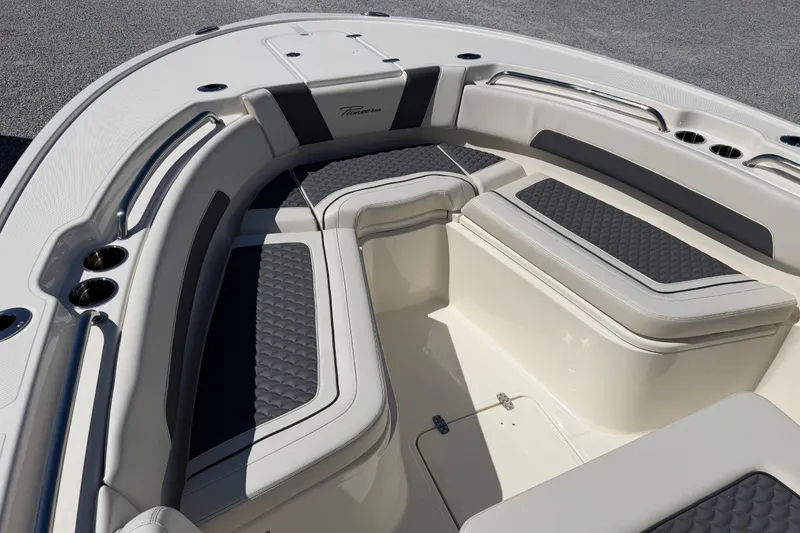 Slide: The Image of 2026 Pioneer 250 Pelagic boat interior with cushioned seating and stainless steel cup holders. - 17