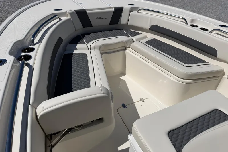 Slide: The Image of 2026 Pioneer 250 Pelagic boat interior with cushioned seating and stainless steel cup holders. - 19