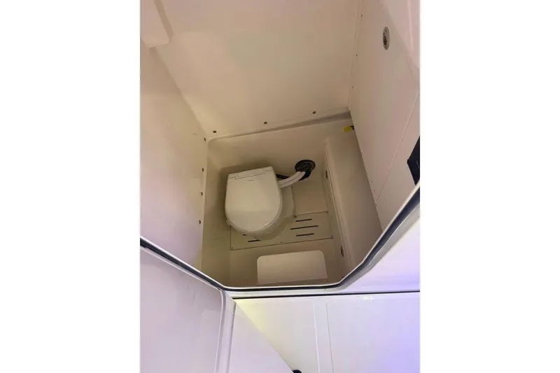 Slide: The Image of 2026 Pioneer 250 Pelagic boat interior with compact marine toilet. - 4
