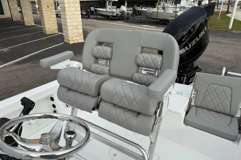 Slide: The Image of 2026 Blazer PureBay 2200 boat with luxurious gray seating and Suzuki engine. - 11