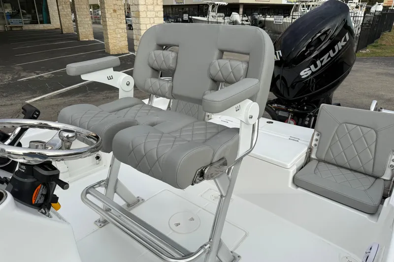 Slide: The Image of 2026 Blazer PureBay 2200 boat interior with Suzuki engine, featuring luxurious gray seating. - 12