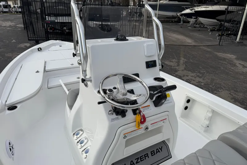 Slide: The Image of 2026 Blazer PureBay 2200 boat interior with steering console and seating. - 14