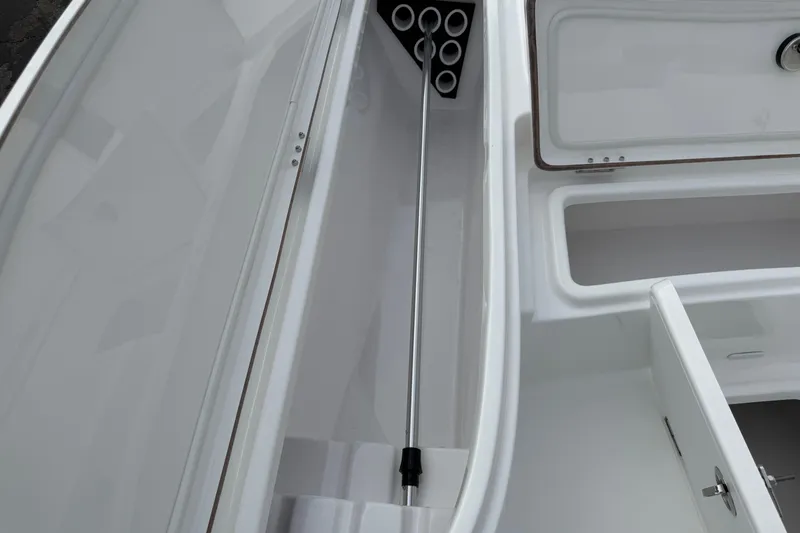 Slide: The Image of 2026 Blazer PureBay 2200 boat storage compartment with rod holders and hatch. - 34