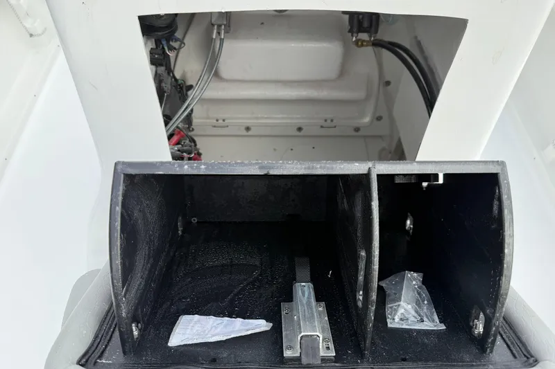 Slide: The Image of 2026 Blazer PureBay 2200 boat storage compartment with visible wiring and components. - 41
