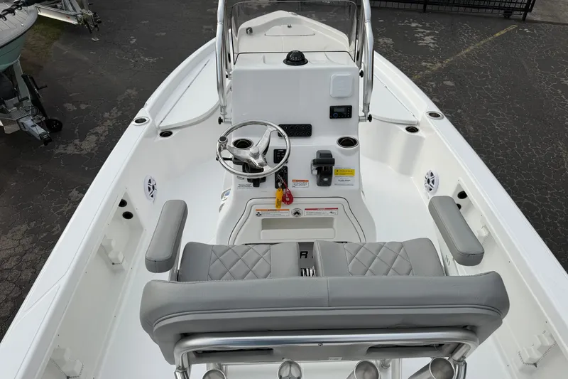 Slide: The Image of 2026 Blazer PureBay 2200 boat interior with steering console and seating. - 9