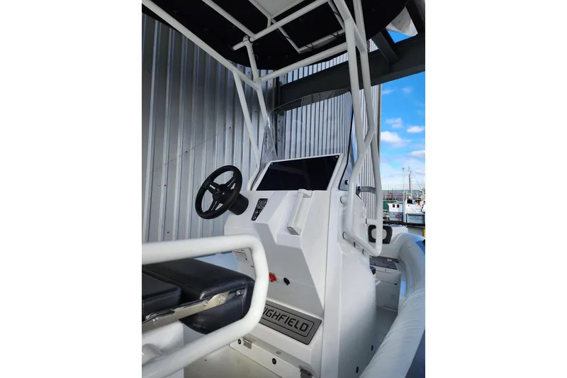 Slide: The Image of 2026 Highfield Sport 560 boat console with steering wheel and navigation display. - 10