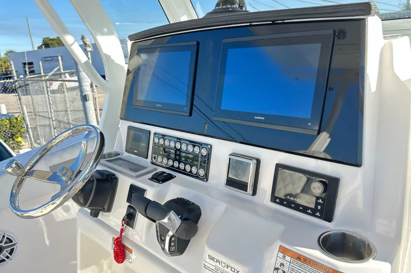 Slide: The Image of 2026 Sea Fox 288 Commander dashboard with dual Garmin displays and steering wheel. - 3