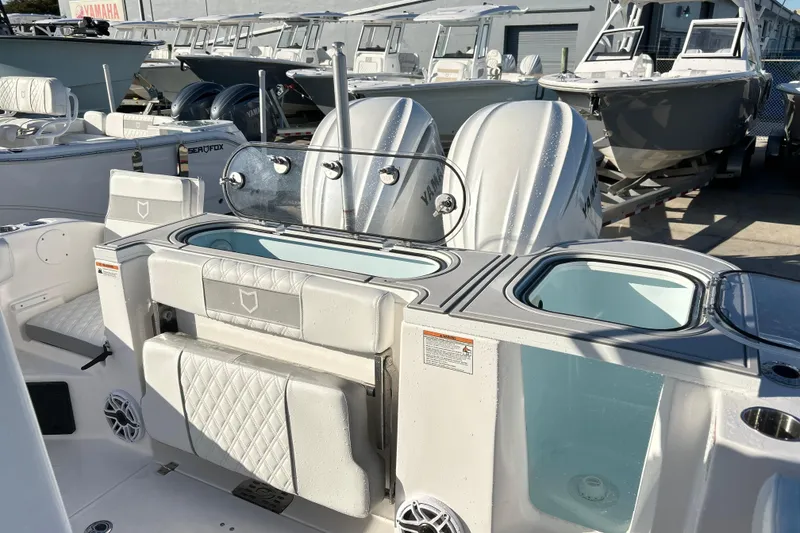 Slide: The Image of 2026 Sea Fox 288 Commander boat interior with dual Yamaha engines, docked among other boats. - 7