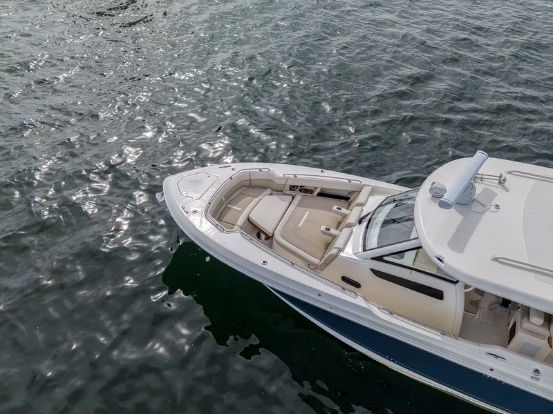 Slide: The Image of A 2027 Scout 288 Dorado on calm water. The boat features a sleek design with comfortable seating. - 6