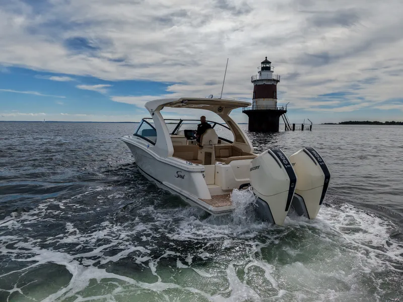 Slide: The Image of 2027 Scout 288 Dorado cruising near a lighthouse on the open sea. - 4