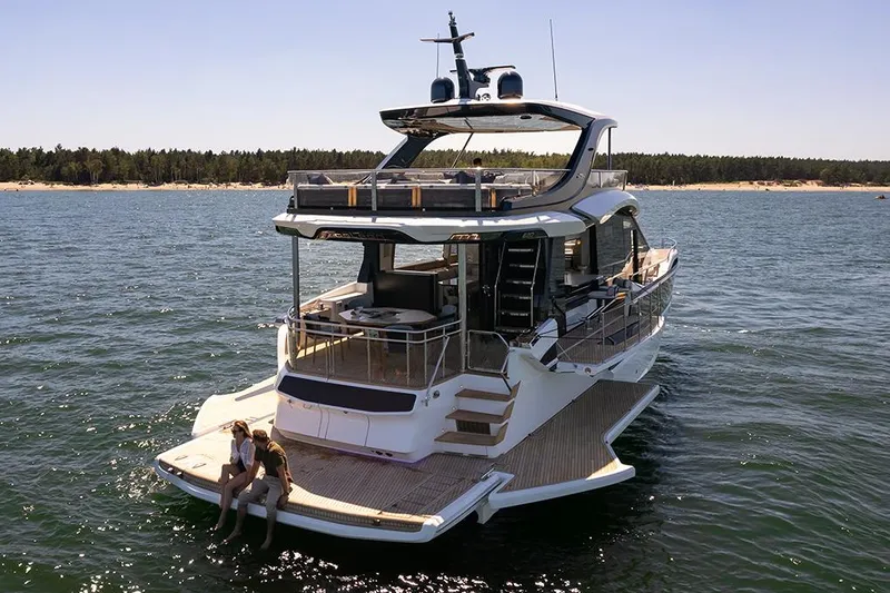 Slide: The Image of Manufacturer Provided Image: 2025 Galeon 620 FLY yacht on water, featuring spacious deck and modern design. - 2