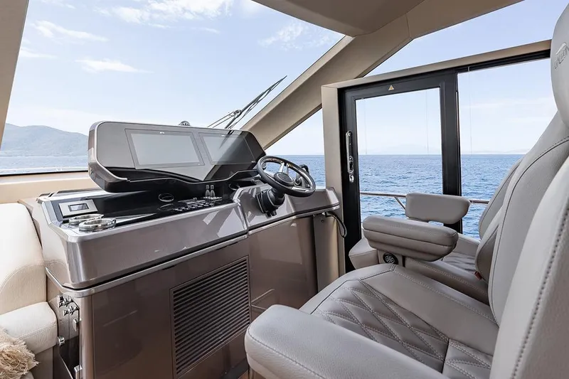 Slide: The Image of Manufacturer Provided Image: Helm of 2025 Galeon 620 FLY yacht with modern controls and ocean view. - 8