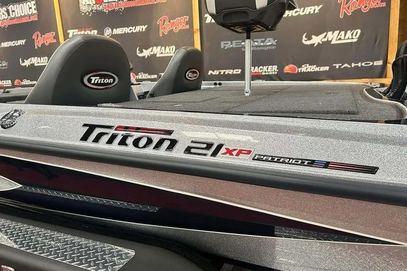 Slide: The Image of 2026 Triton 21XP Patriot boat interior with branded seating and logo details. - 14