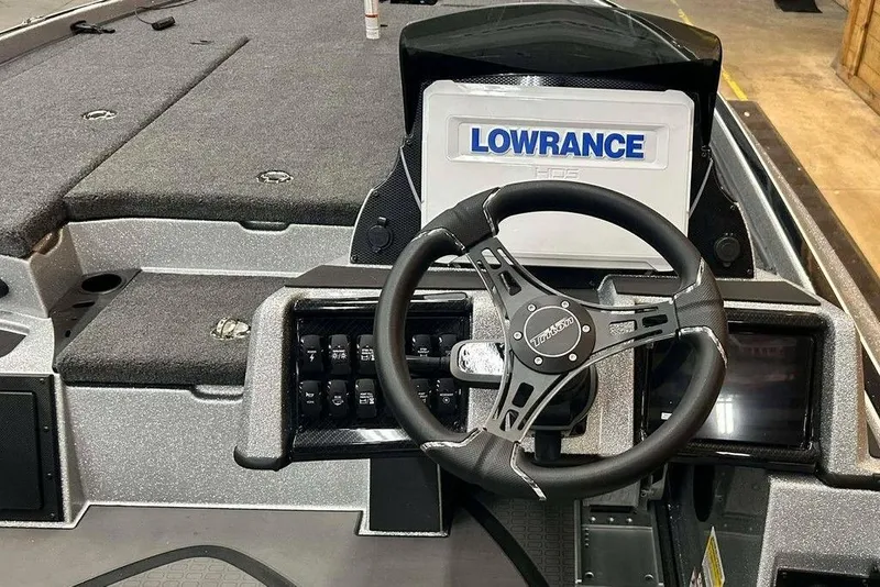 Slide: The Image of 2026 Triton 21XP Patriot boat dashboard with Lowrance display and steering wheel. - 4