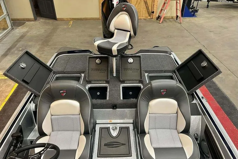 Slide: The Image of 2026 Triton 21XP Patriot boat interior with seating and storage compartments. - 9
