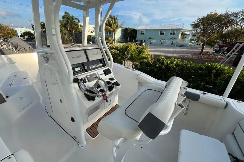 Slide: The Image of 2017 Tidewater 230 CC Adventure boat interior with Garmin navigation system and seating. - 14