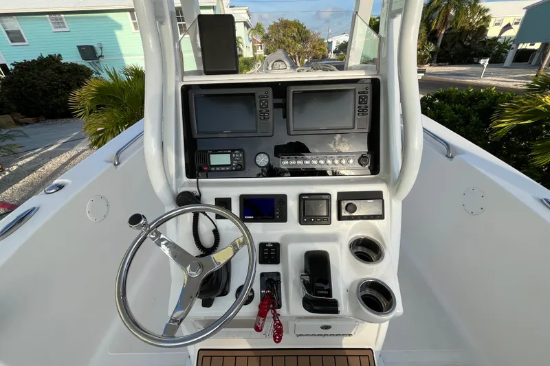 Slide: The Image of 2017 Tidewater 230 CC Adventure boat console with steering wheel and navigation equipment. - 16