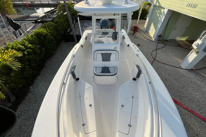 Slide: The Image of 2017 Tidewater 230 CC Adventure boat docked, showcasing spacious deck and seating area. - 7