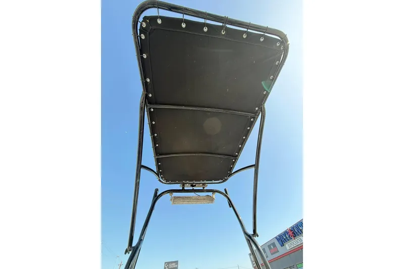 Slide: The Image of T-top canopy of 2018 Blazer Bay 2420 GTS boat against clear blue sky. - 3
