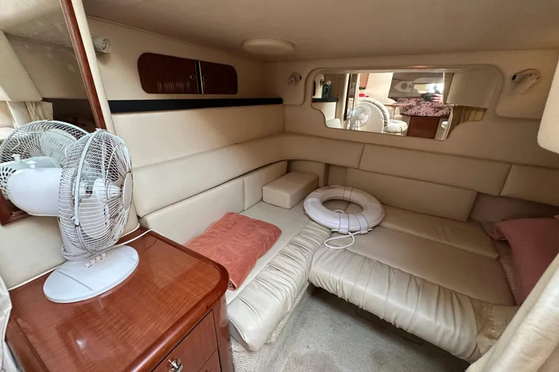 Slide: The Image of 2002 Sea Ray 340 Sundancer cabin interior with seating, fan, and life preserver. - 26