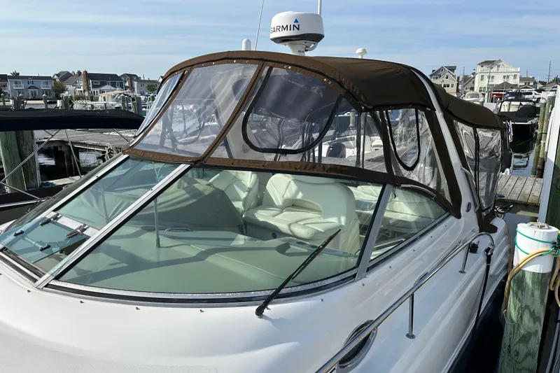Slide: The Image of 2002 Sea Ray 340 Sundancer docked, featuring a brown canopy and Garmin radar. - 5
