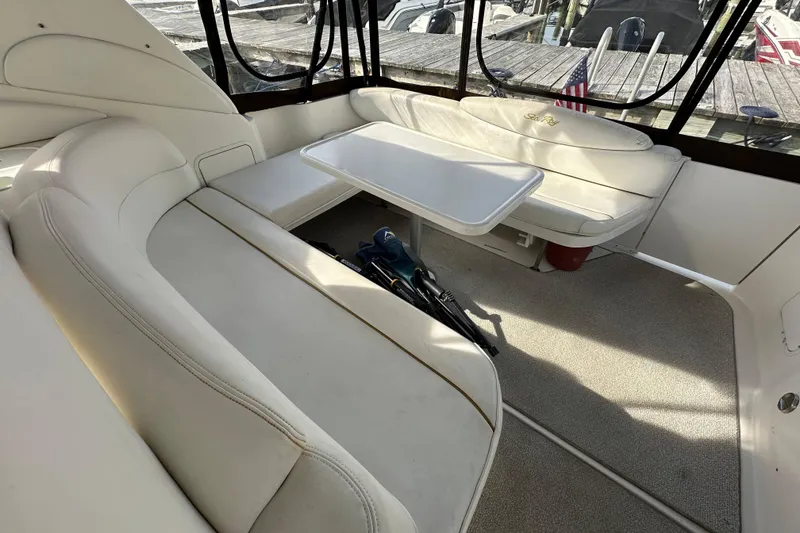 Slide: The Image of Interior of 2002 Sea Ray 340 Sundancer with white seating and table. - 6