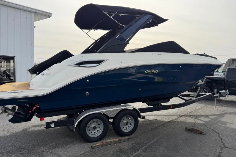 The Image of 2024 Sea Ray SDX 250 boat on trailer, parked outdoors. - 1
