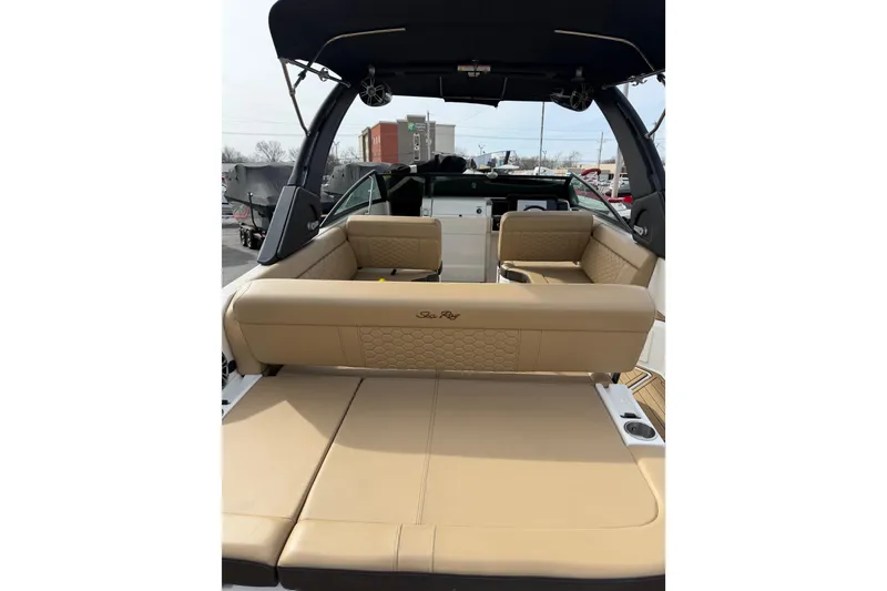 Slide: The Image of 2024 Sea Ray SDX 250 boat interior with tan seating and black canopy. - 3