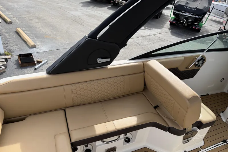 Slide: The Image of 2024 Sea Ray SDX 250 boat interior with beige seating and modern design. - 5