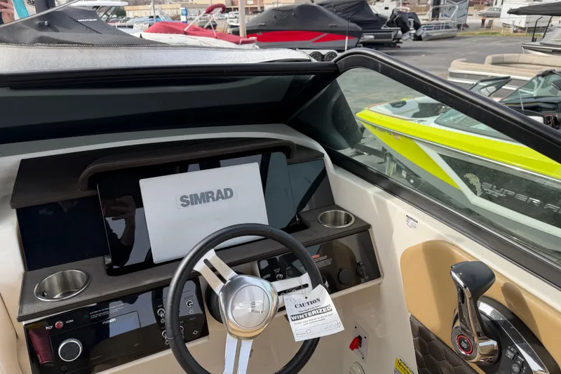 Slide: The Image of 2024 Sea Ray SDX 250 boat dashboard with Simrad display and steering wheel. - 6