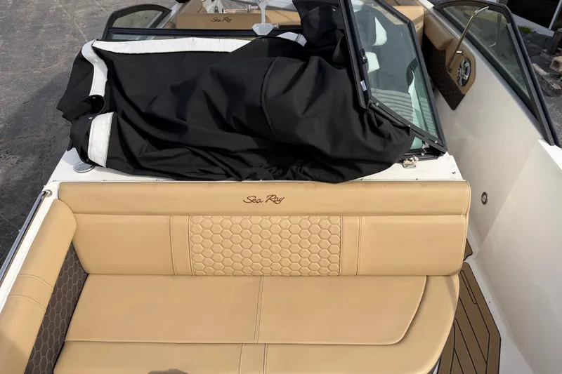 Slide: The Image of 2024 Sea Ray SDX 250 boat interior with tan seating and black cover. - 8