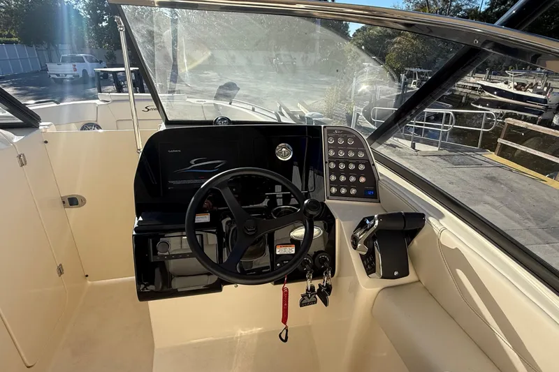 Slide: The Image of 2026 Scout 255 Dorado boat cockpit with steering wheel and control panel. - 14